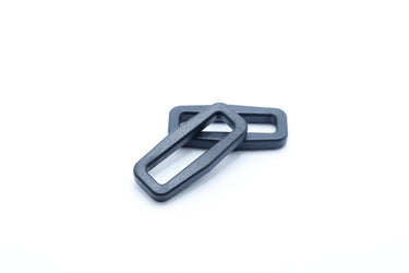 Black plastic rectangle loop attachment point shown from the side for outdoor gear webbing